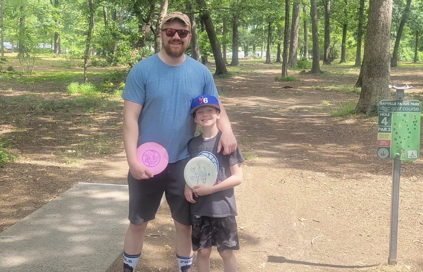 Jeff Richter and his son, Henry, at a disc golf course